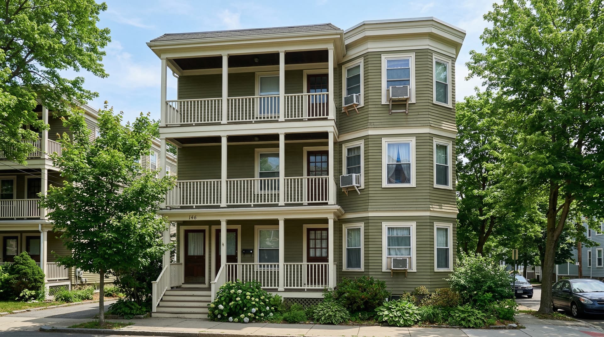 Typical Massachusetts triple-decker with window AC units visible