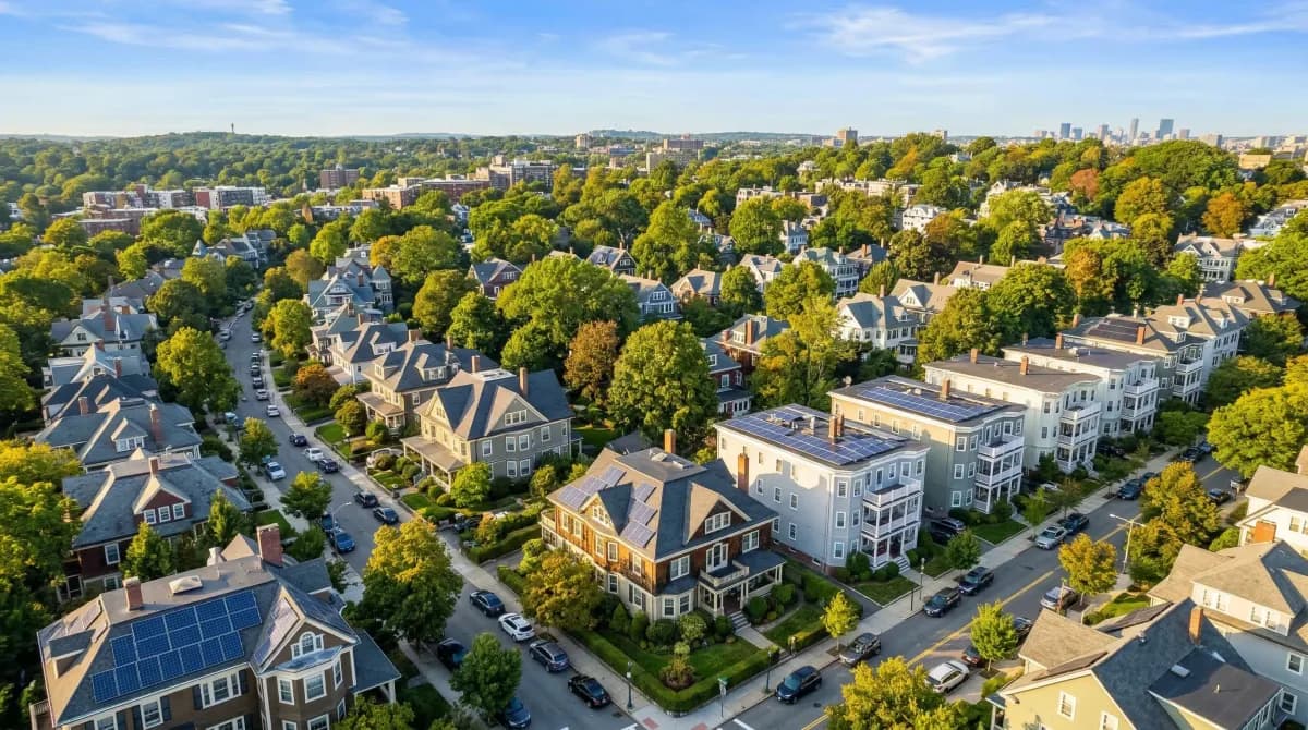 Aerial view of Brookline Massachusetts residential neighborhoods with solar panels on Victorian rooftops