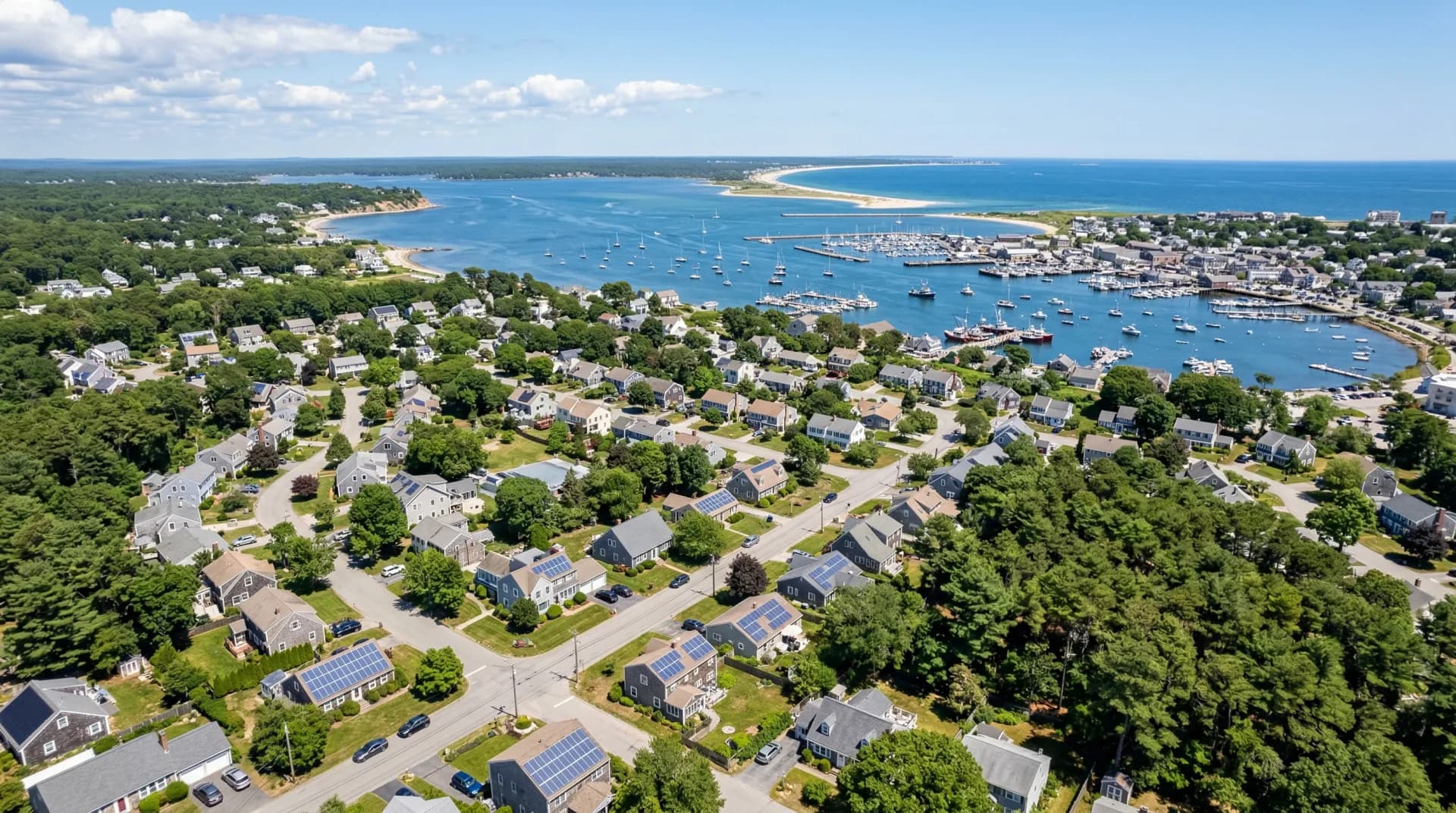 Aerial view of Plymouth Massachusetts with solar panels on residential rooftops