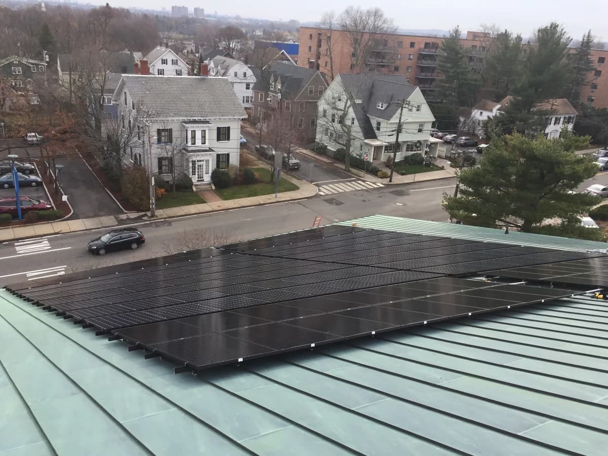 Solar panels clamped to the standing-seam copper roof at First Parish Arlington