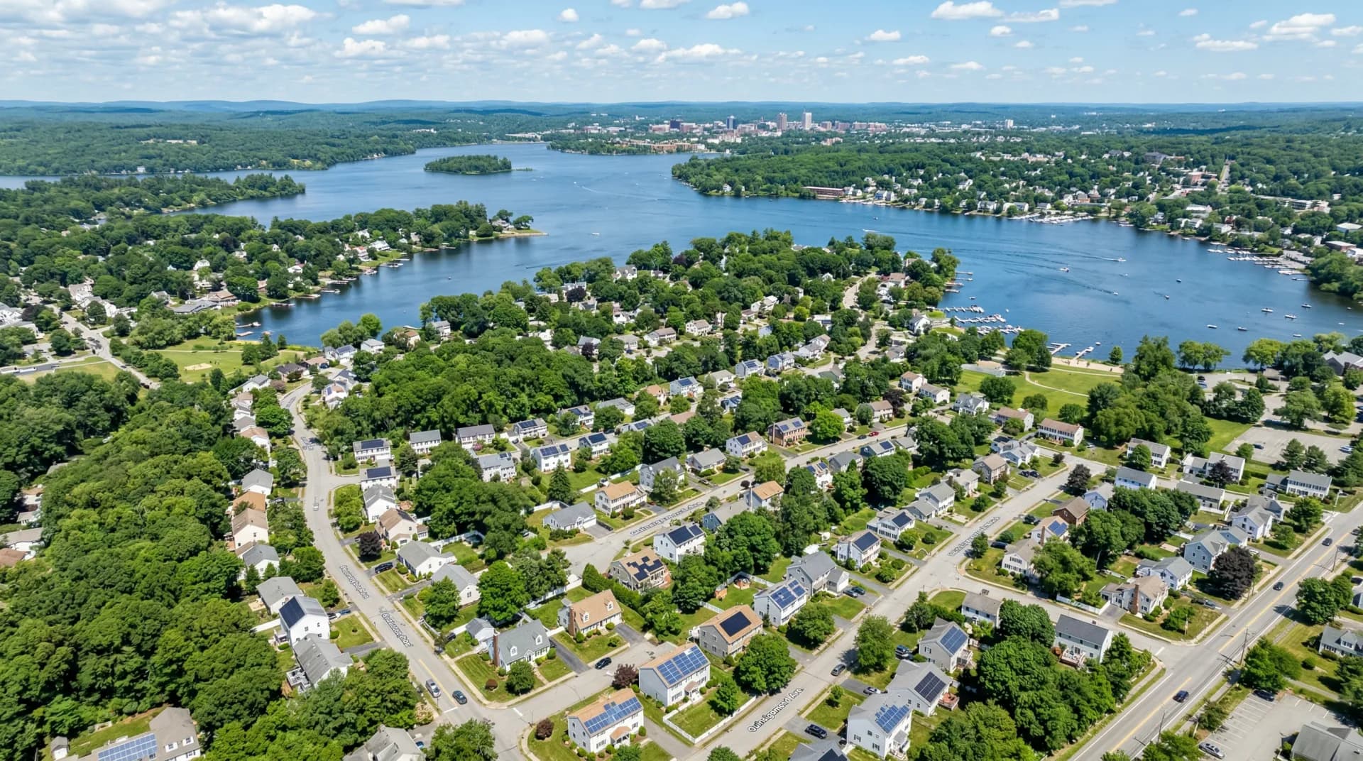 Aerial view of Shrewsbury Massachusetts with solar panels on residential rooftops