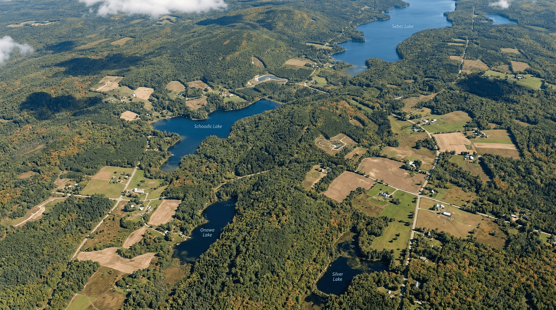 Aerial view of rural Maine landscape showing mix of forest and open clearings suitable for ground-mount solar