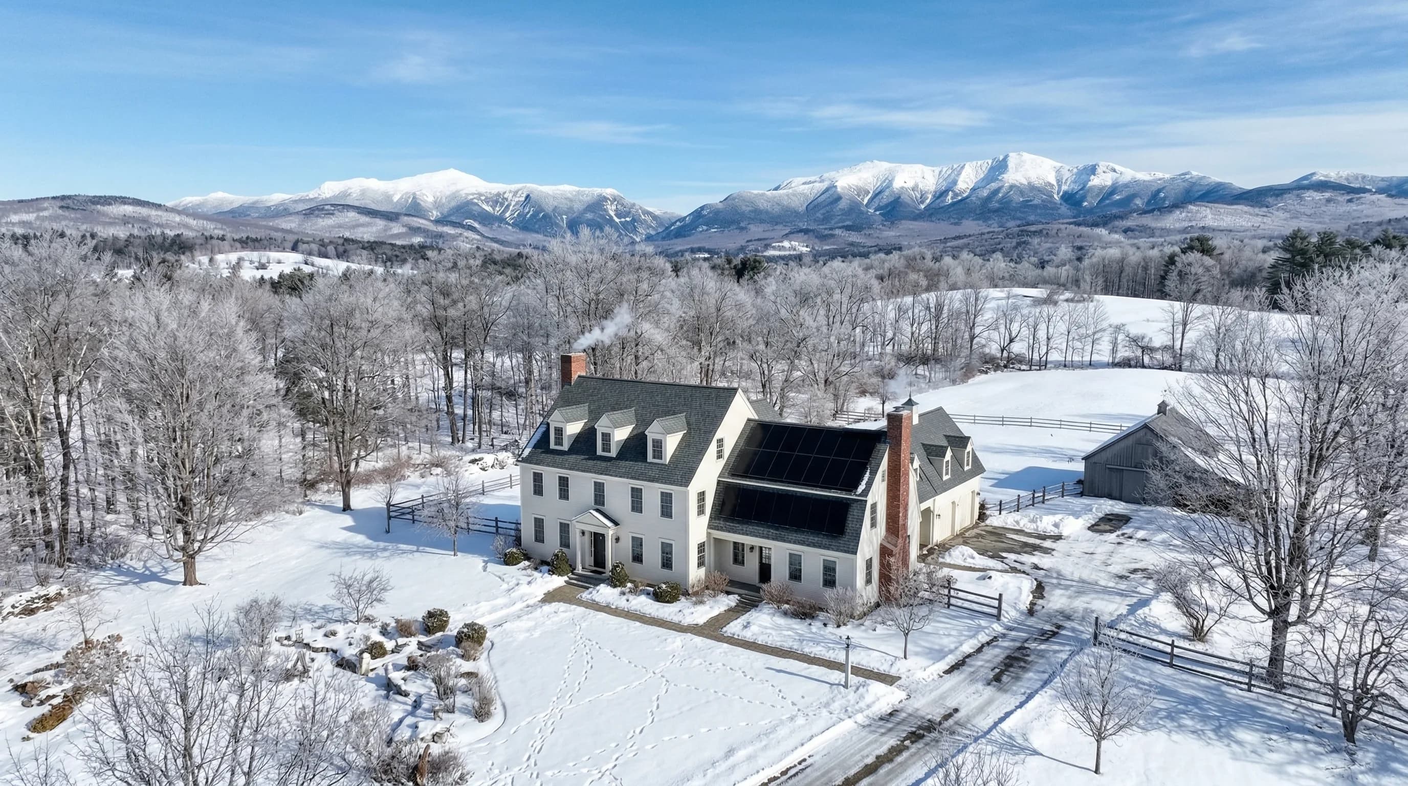 Solar panels on a New Hampshire colonial home with White Mountains in background