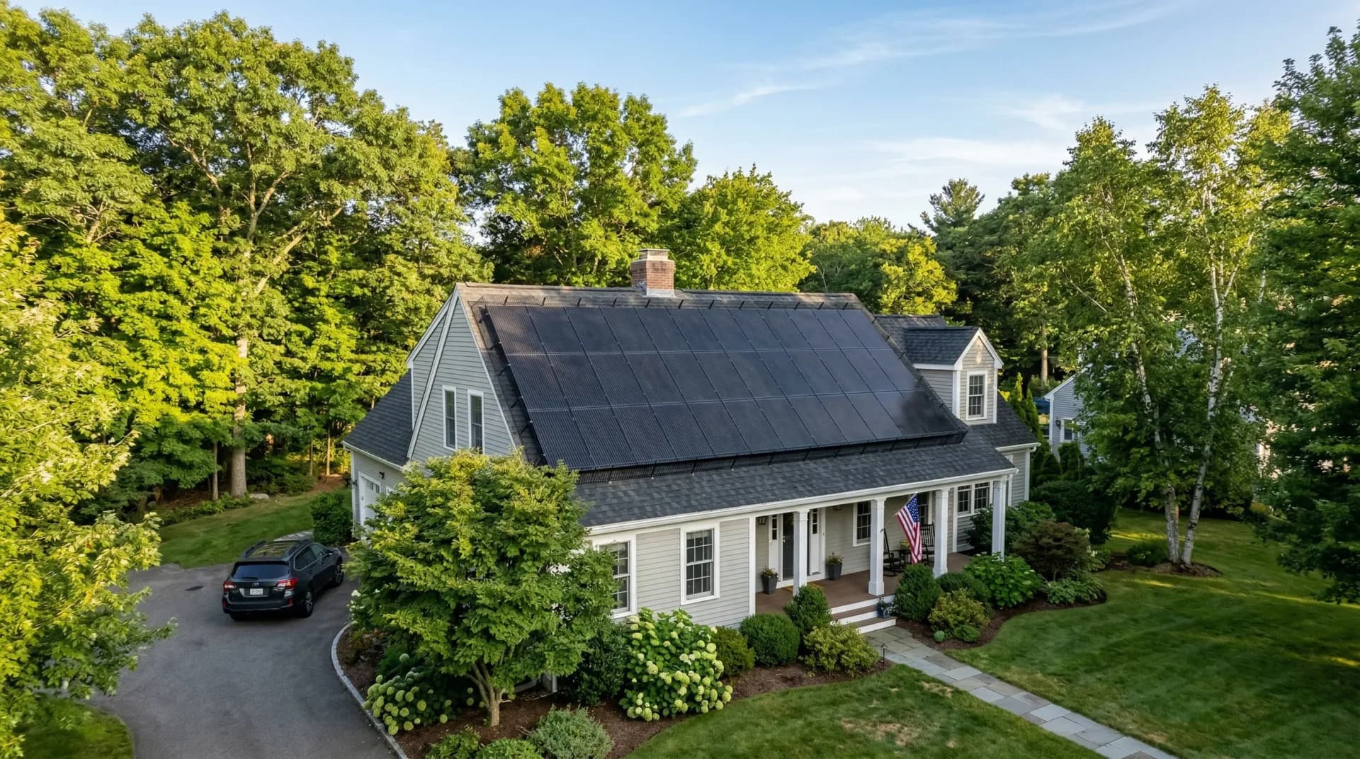 Solar critter guard mesh installed around solar panels on a Massachusetts suburban home roof