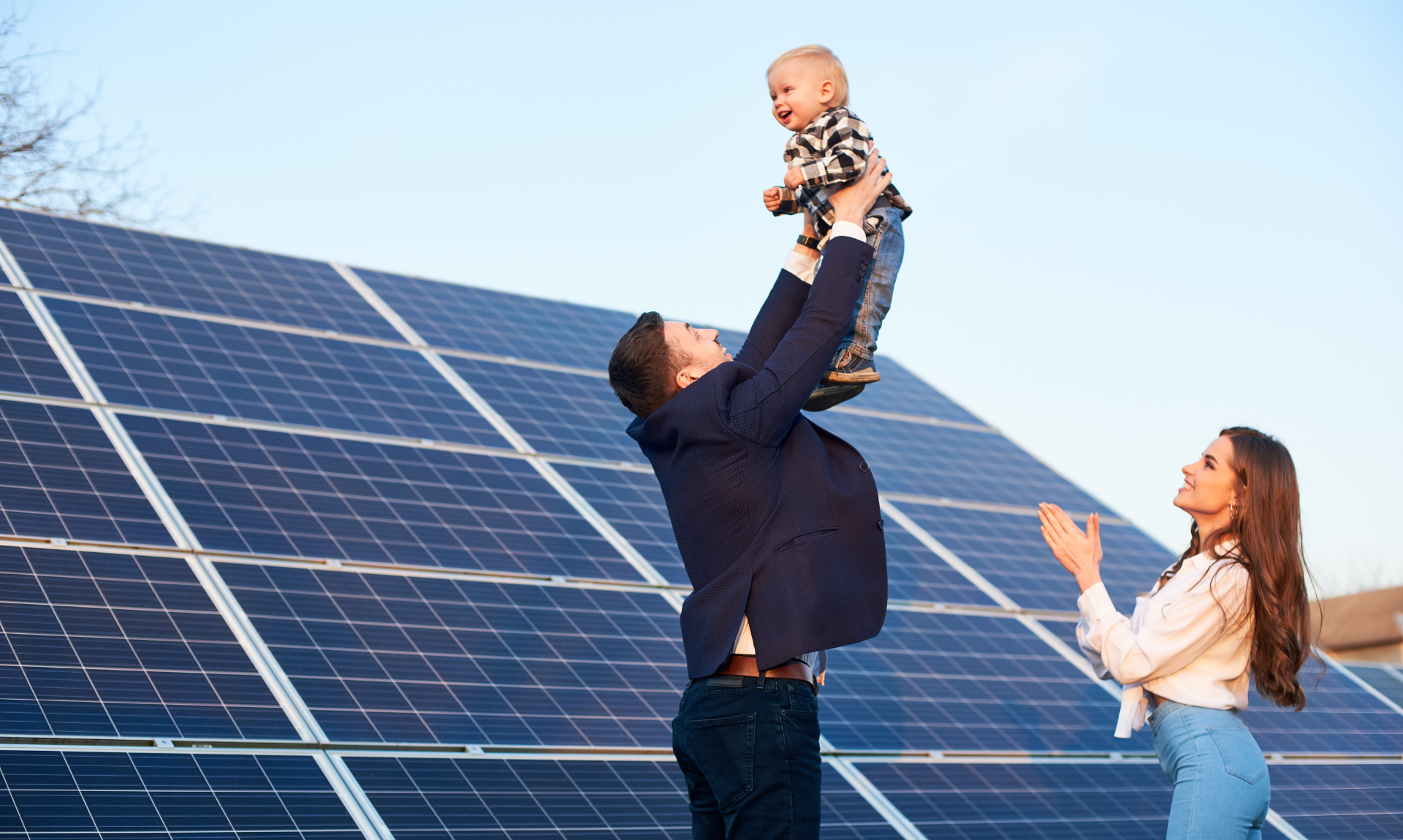 Happy family spending time in front of solar panels.